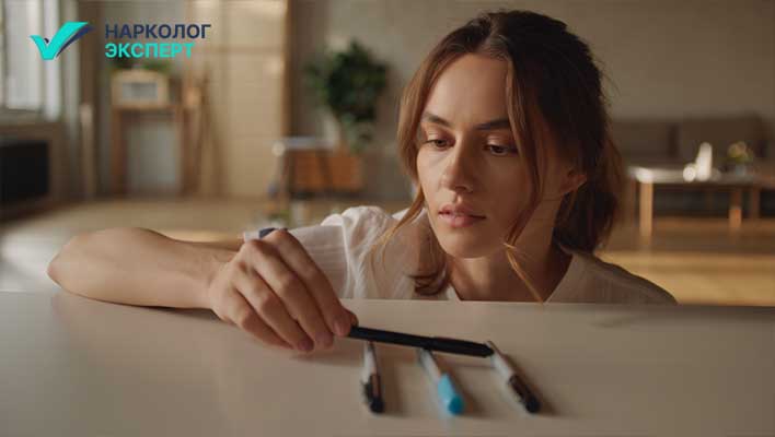 Девушка поправляет ручки на столе